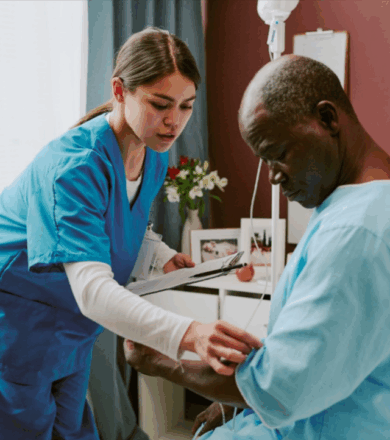 A nurse checks on an elderly male patient seated on a hospital bed during routine rounds.