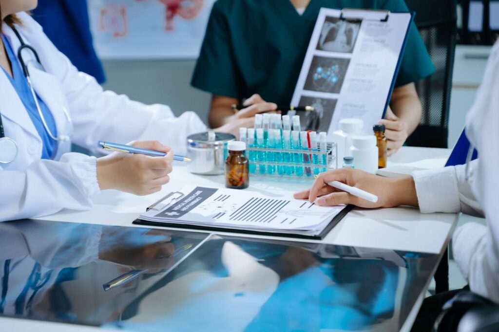 A team of clinical research nurses work in a lab with vials and notes.