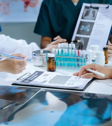 A team of clinical research nurses work in a lab with vials and notes.