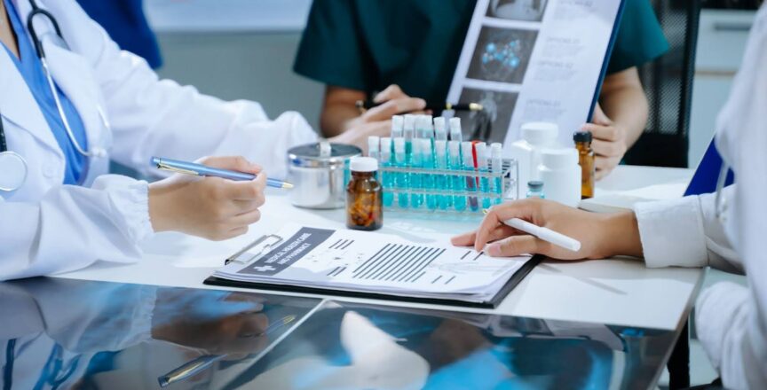 A team of clinical research nurses work in a lab with vials and notes.