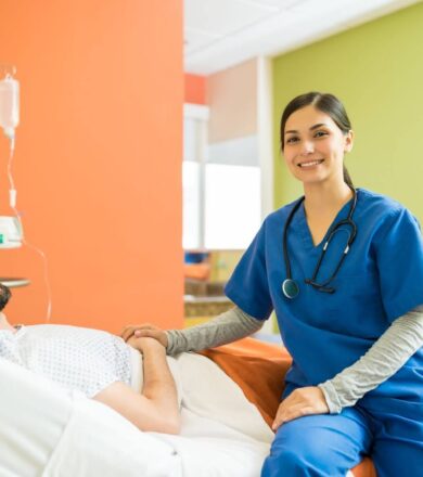 A nurse smiles while examining a patient on a hospital bed.