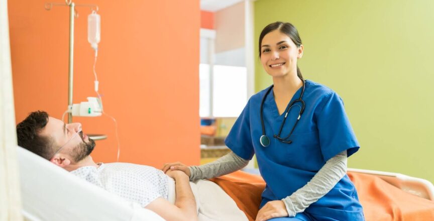 A nurse smiles while examining a patient on a hospital bed.