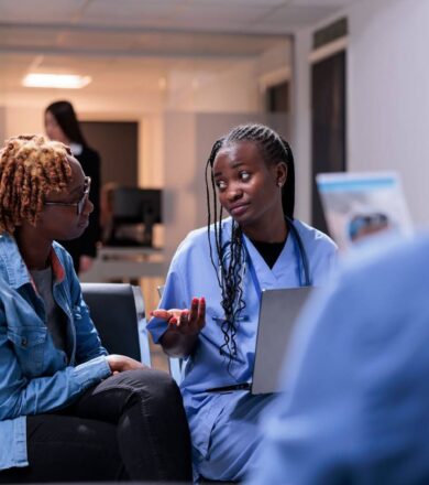 Nurse speaking to a patient in a waiting room.