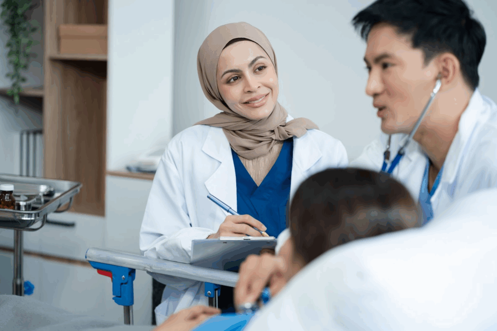 Medical professionals speaking to a patient in a bed.