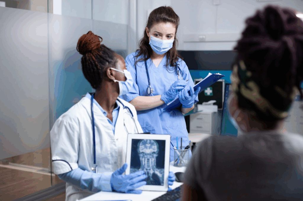 A doctor and a nurse discuss how best to treat a patient.